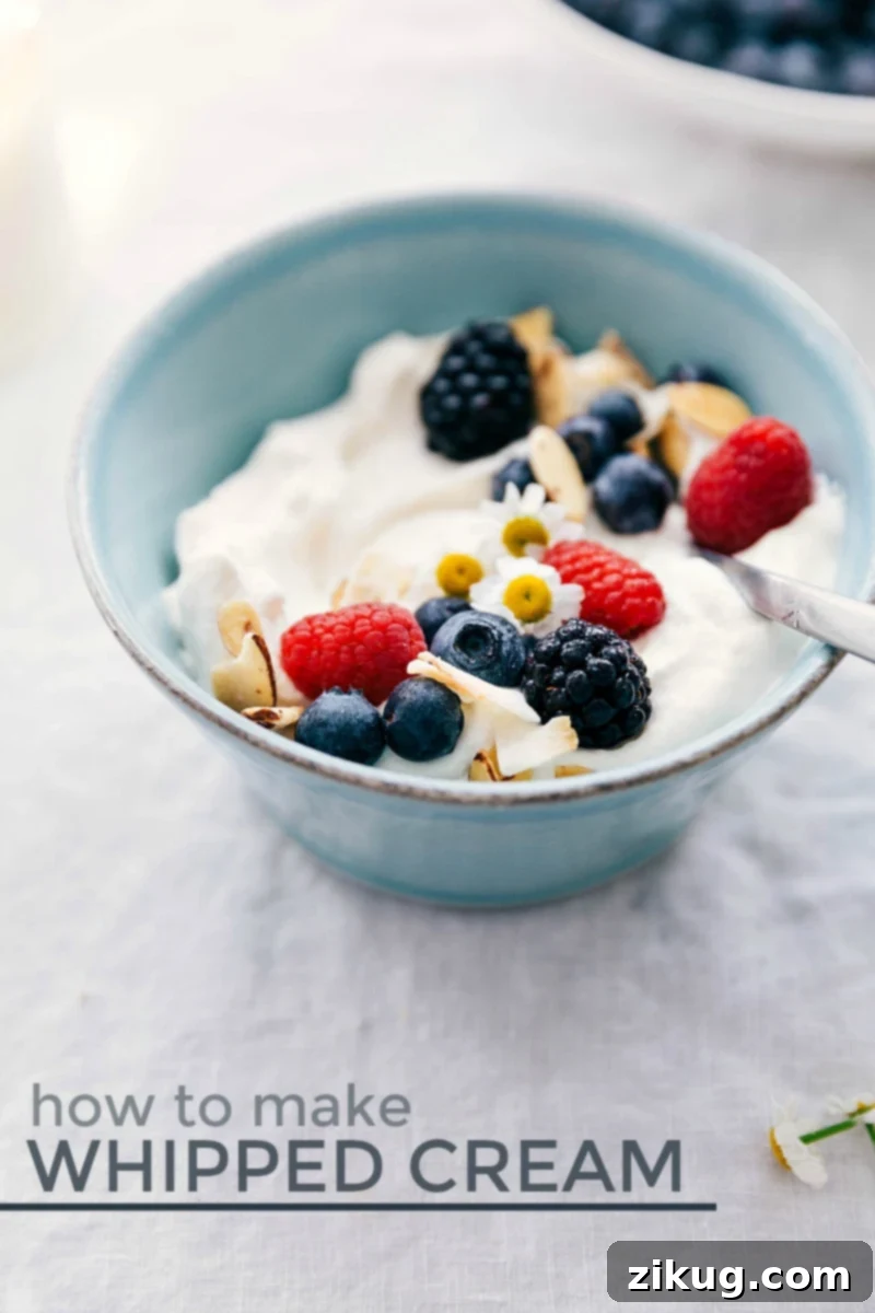 Discover the easy steps, expert tips, and clever tricks to make delicious, perfect whipped cream for all your desserts. A vibrant bowl of fresh berries topped with a generous dollop of homemade whipped cream, showcasing its fluffy texture.