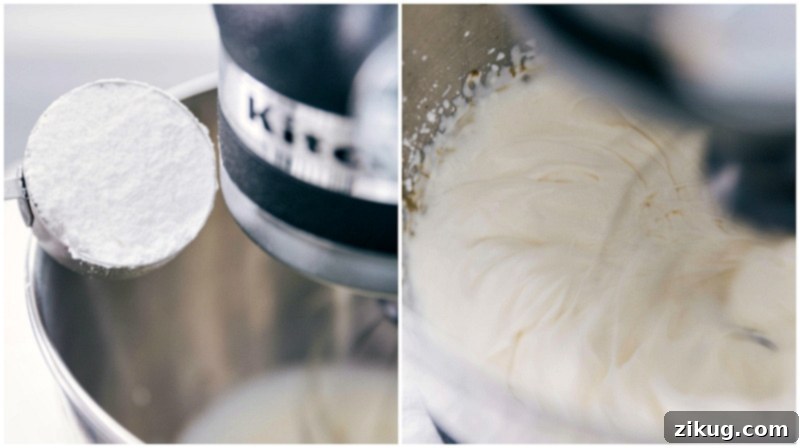 Learn how to craft the BEST homemade whipped cream with this comprehensive guide! A stream of powdered sugar being added to heavy whipping cream in a mixer bowl.