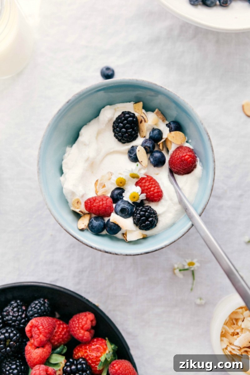 Learn how to create exquisite whipped cream from scratch using just three simple ingredients: heavy whipping cream, powdered sugar, and vanilla extract. Homemade whipped cream served with various fruits and nuts, showing its versatility as a dessert topping.