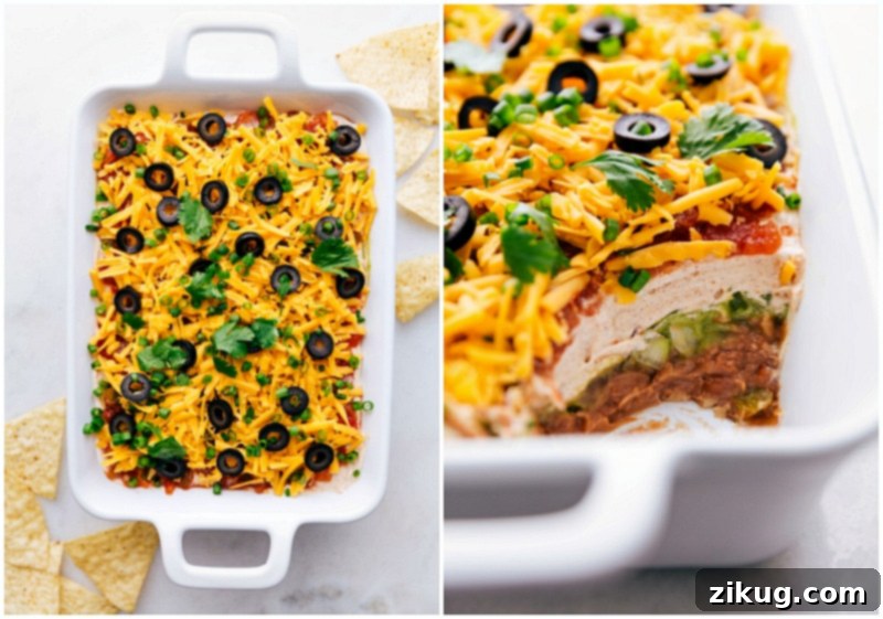 Delicious and easy 7 Layer Bean Dip A close-up of a 7-Layer Bean Dip with a scoop missing, revealing the vibrant and delicious layers beneath the surface.