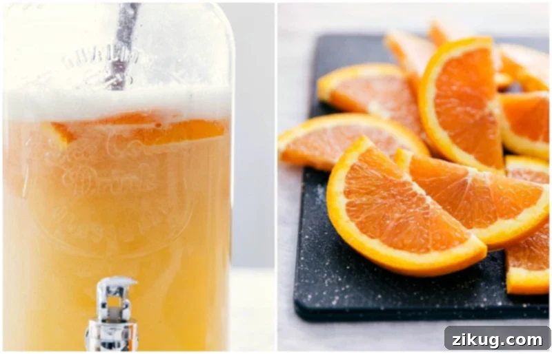 Bright Cara Cara orange slices being gently added to a large pitcher of the punch, enhancing its visual appeal.