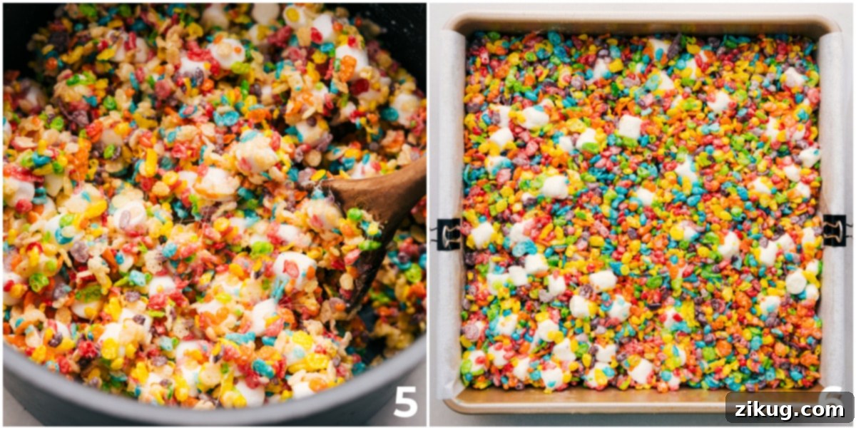 The combined Fruity Pebble and marshmallow mixture being spread evenly into a 9x9 inch pan, ready to cool and harden.