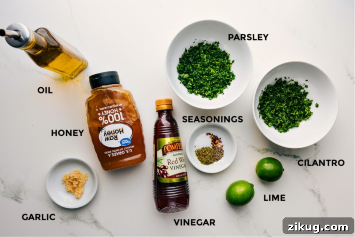 Ingredients In Chimichurri Chicken Ingredients prepped for easy assembly, including oil, honey, garlic, seasonings, parsley, cilantro, limes, and vinegar.