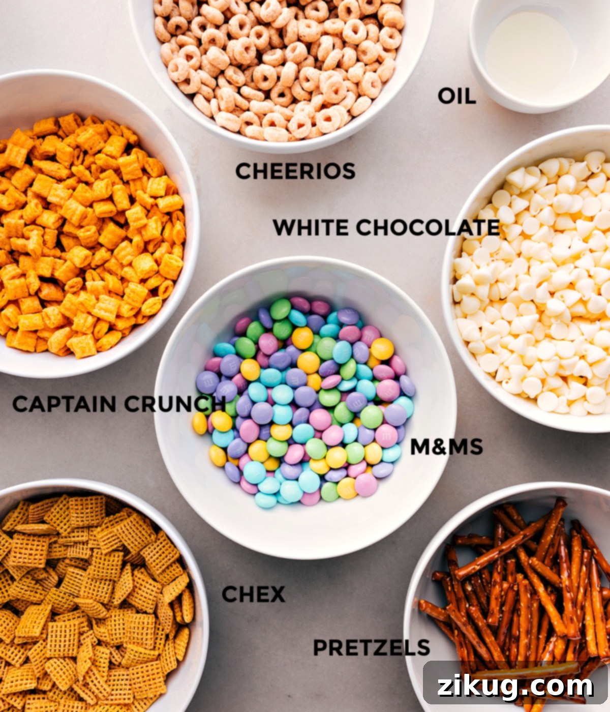 All the essential ingredients meticulously prepped for Bunny Bait: Cheerios, vegetable oil, white chocolate chips, Cap’n Crunch, M&Ms, mini pretzels, and Chex cereal.