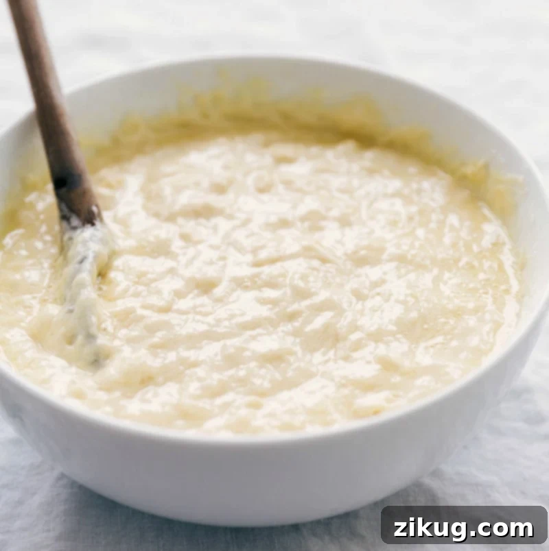 Perfect Waffle Batter: Light and fluffy inside with a nice crisp exterior. Waffle batter perfectly mixed in a bowl, ready for the waffle iron.