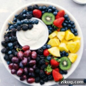 A vibrant image of the easy fruit dip served in a bowl, surrounded by an assortment of colorful fresh fruits ready for dipping.