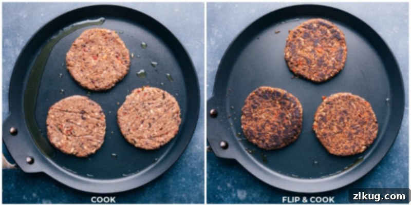 Close-up of three black bean burgers sizzling on a hot grill or pan, with one burger being flipped to reveal a perfectly golden-brown and crispy exterior, indicating they are fully cooked and ready to serve.