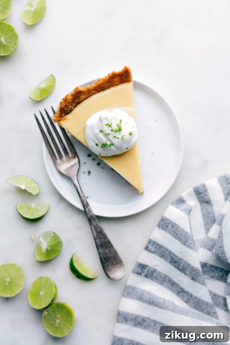 Key Lime Pie Slice - Creamy and Tangy Delight Slice of creamy key lime pie with a dollop of whipped cream on top, garnished with lime zest.