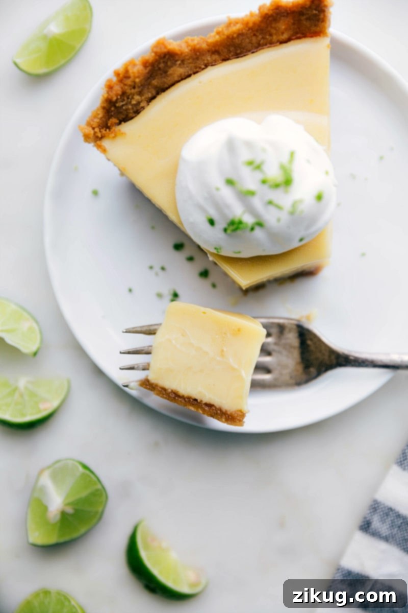 Slice of Key Lime Pie with Bite Taken Out A delicious sweet and tangy slice of dessert with a bite taken out of it, showcasing the creamy filling and crisp crust.