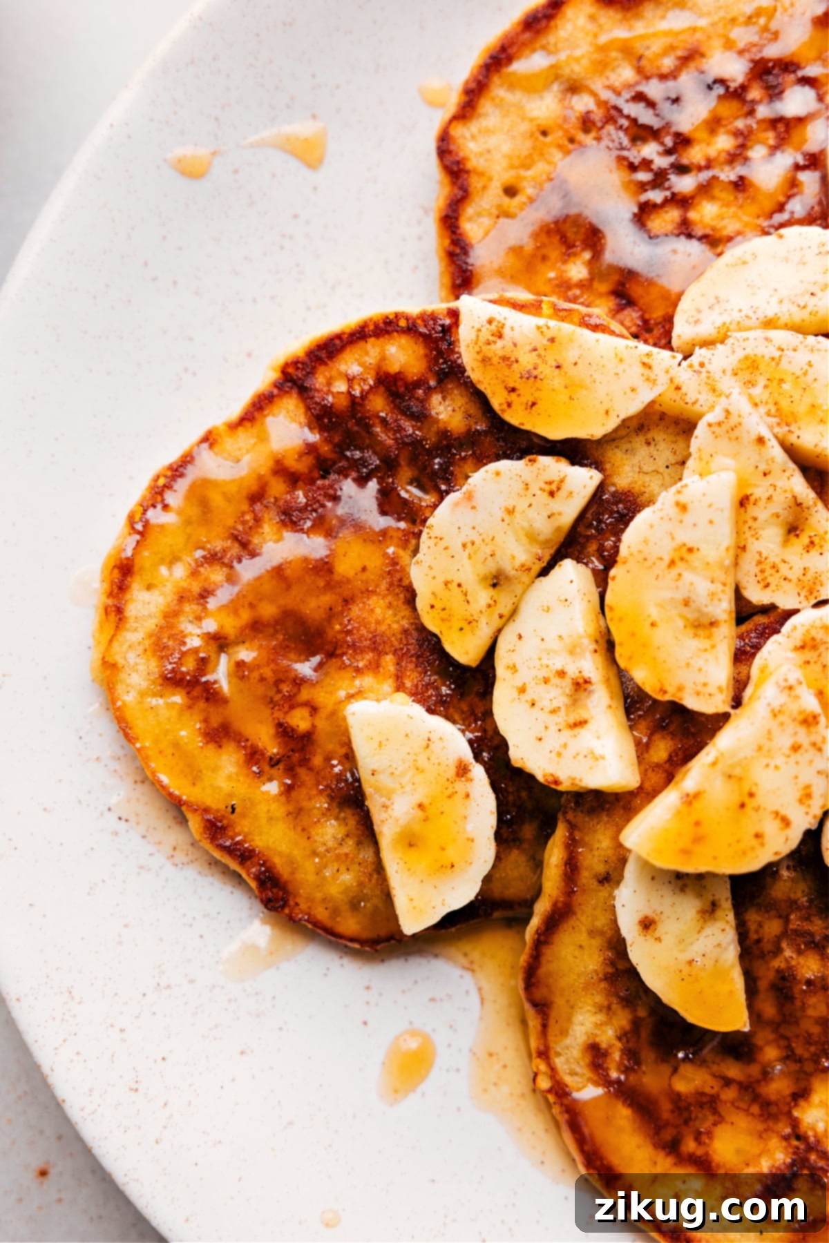 Piping Hot Banana Pancakes Fresh Off the Griddle Freshly cooked banana pancakes straight off the griddle, perfectly stacked and ready to be savored, brimming with flavor and topped with a luscious drizzle of syrup.