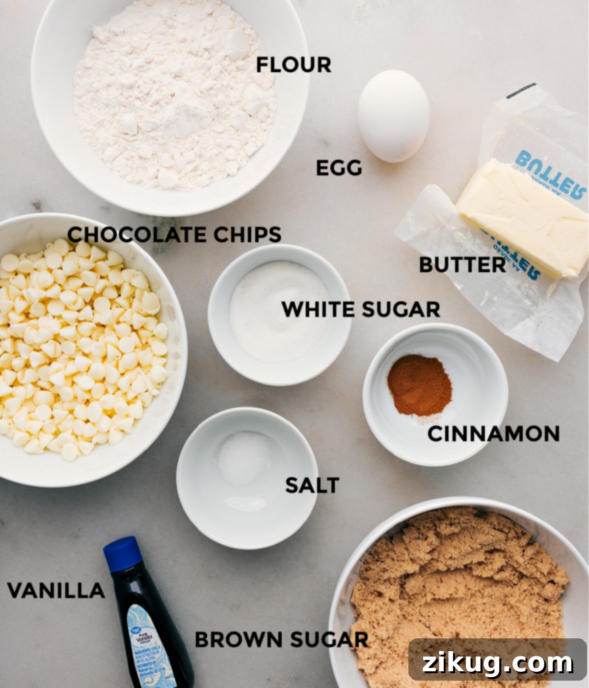 All the ingredients for Snickerdoodle Blondies including white chocolate chips, egg, brown sugar, cinnamon, salt, browned butter, and flour, neatly prepped for baking.