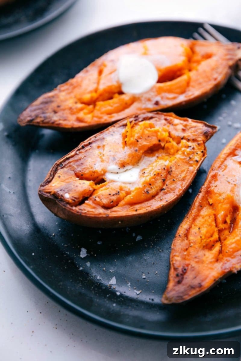 Oven-Roasted Baked Potatoes Recipe A close-up shot of a steaming, freshly baked sweet potato, golden brown and cut open, with a generous pat of butter slowly melting into its soft, orange flesh.