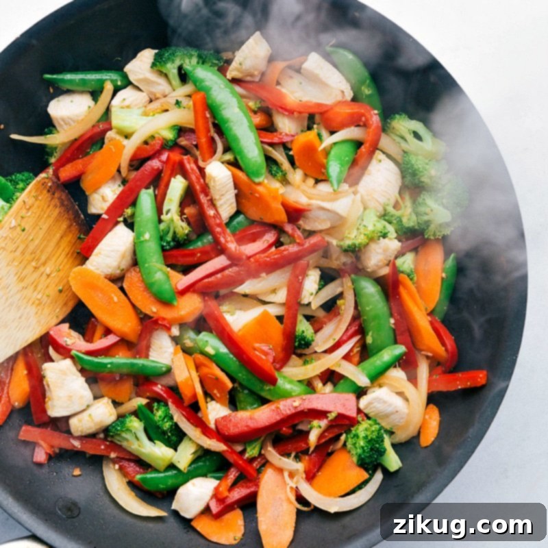 Wok-Tossed Chicken Dinner 3 Mixing fresh vegetables and meat in the skillet.
