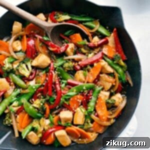 Chicken stir fry in a skillet, brimming with vegetables and rich flavors, prepared for serving.
