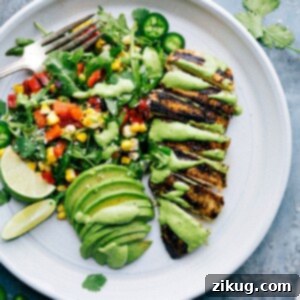 Flavorful Peruvian Chicken Recipe served with a vibrant green sauce and a fresh salad.