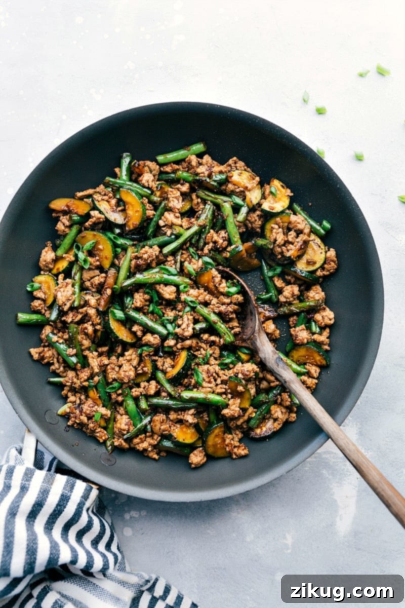 Savory Ground Pork Stir Fry: Perfectly Seasoned and Ready in the Skillet Sizzling ground pork stir fry in a skillet, seasoned perfectly with vibrant vegetables, ready to serve as a delicious and quick meal.