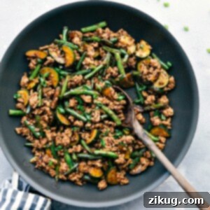 Sizzling Pork Mince Stir-Fry 3 Pork stir fry sizzling in a skillet, seasoned to perfection and ready for a delightful meal.