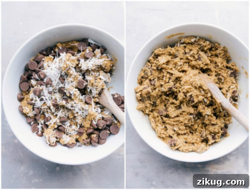 Mixing Chocolate Chips and Coconut into Cookie Dough The final step of mixing, as chocolate chips and shredded coconut are folded into the rich cookie dough, promising a delightful blend of flavors and textures in these oatmeal coconut cookies.