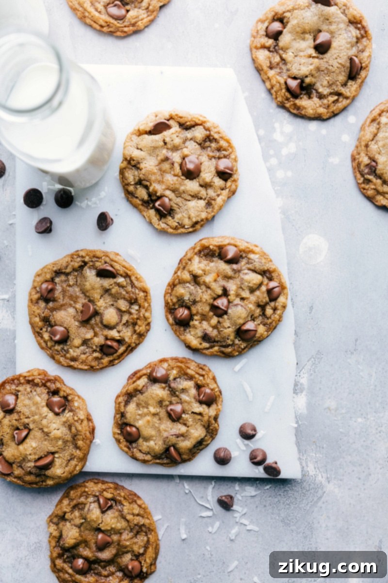 Freshly Baked Batch of Oatmeal Coconut Chocolate Chip Cookies A freshly baked batch of delightful oatmeal coconut chocolate chip cookies, stacked and ready to be savored, showcasing their perfect texture and inviting warmth.