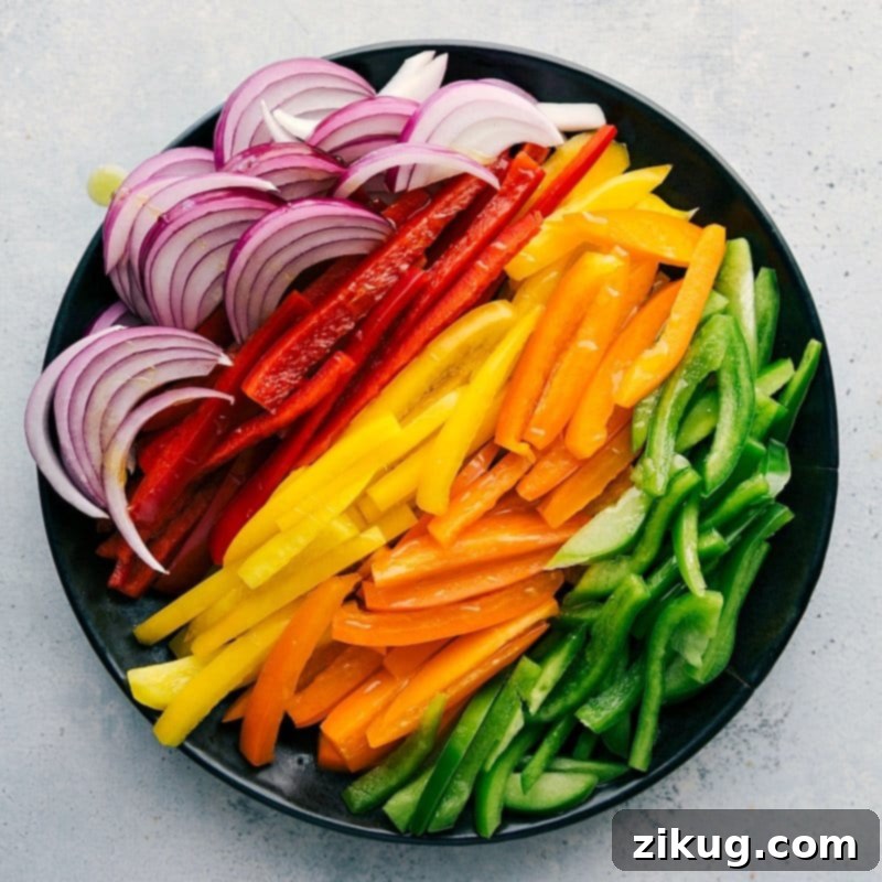 Freshly Sliced Veggies for Flavorful Shrimp Fajitas An assortment of sliced vegetables, including onions and various types of peppers, ready to be used in this recipe.