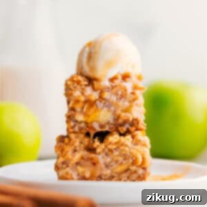 Finished Apple Pie Bars, golden brown with a glistening caramel drizzle, ready to be enjoyed.