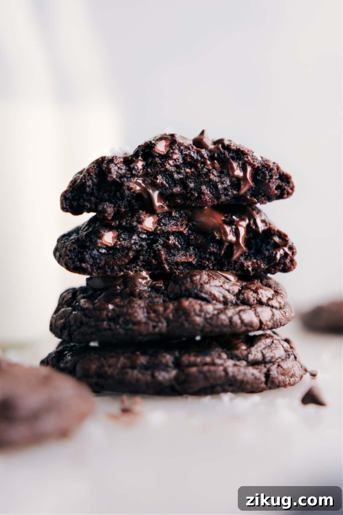 Stack of rich, fudgy chocolate cookies with melted chocolate chips and a sprinkle of sea salt, ready to be enjoyed.