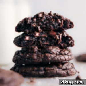 Stack of rich, fudgy chocolate cookies with melted chocolate chips and a sprinkle of sea salt, ready to be enjoyed.