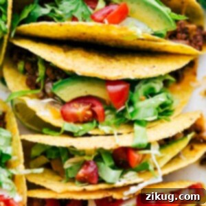 Delicious savory beef tacos in a casserole dish, fully assembled with all the toppings.