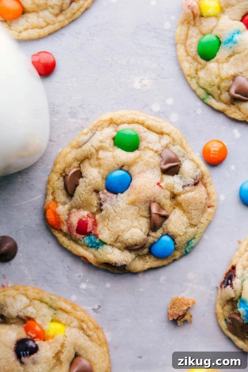 A plate of perfectly baked, vibrant M&M cookies, fresh from the oven and ready to be enjoyed as a delightful treat.