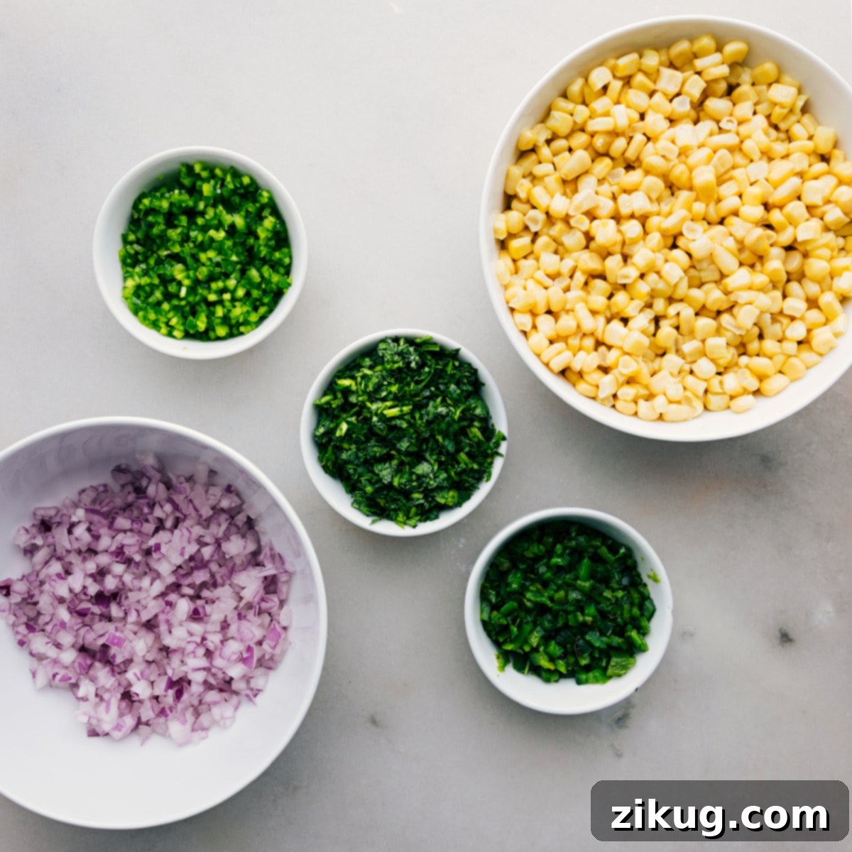 Red onion, cilantro, jalapeño, poblano, and corn prepped out on table Red onion, cilantro, jalapeño, poblano, and corn prepped out on table