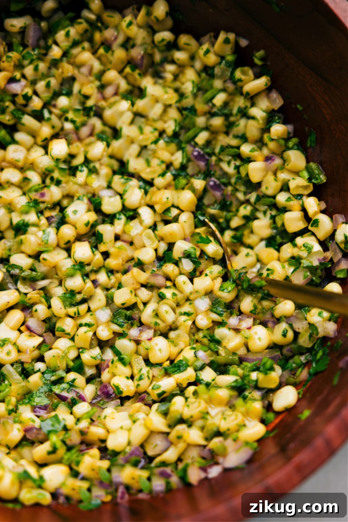 Up close photo of Chipotle Corn Salsa with spoon in it Up close photo of Chipotle Corn Salsa with spoon in it