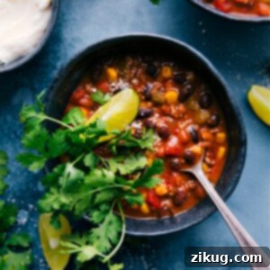 A close-up shot of a steaming bowl of rich Taco Chili, perfectly seasoned and ready to be garnished and enjoyed.