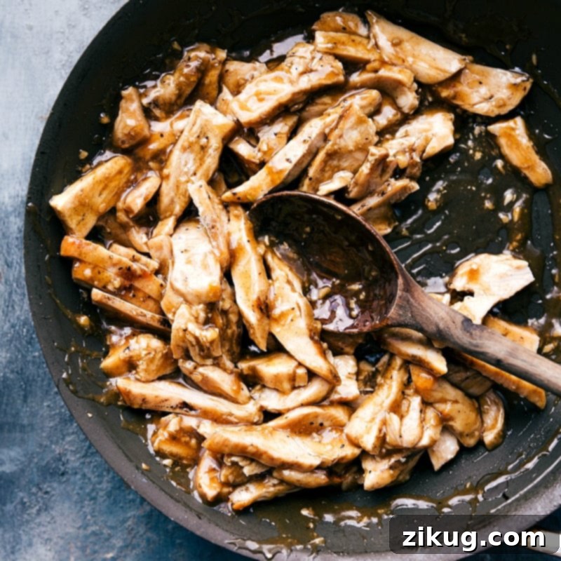 Succulent cooked chicken coated in a rich apricot sauce, served in a saucepan.