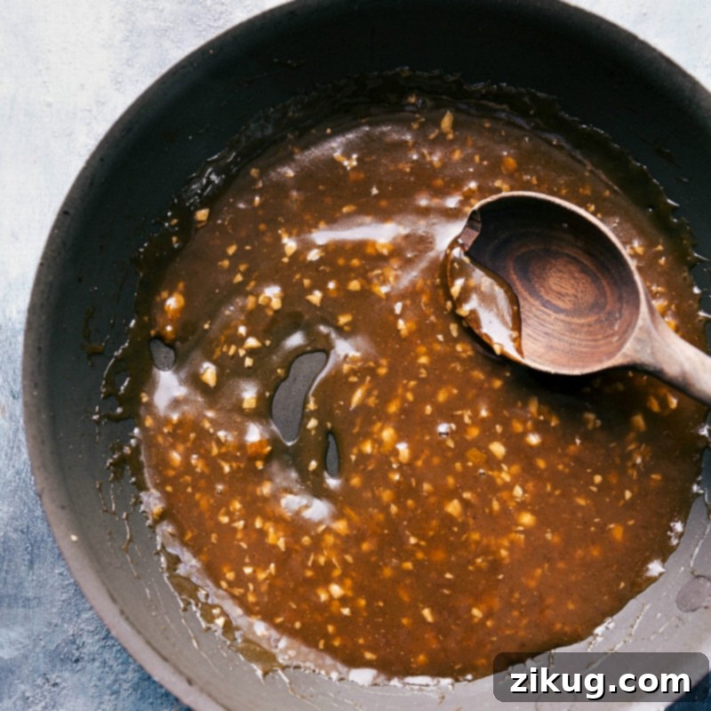Preparing the apricot glaze sauce in a pan, showcasing a sweet and fruity mixture.