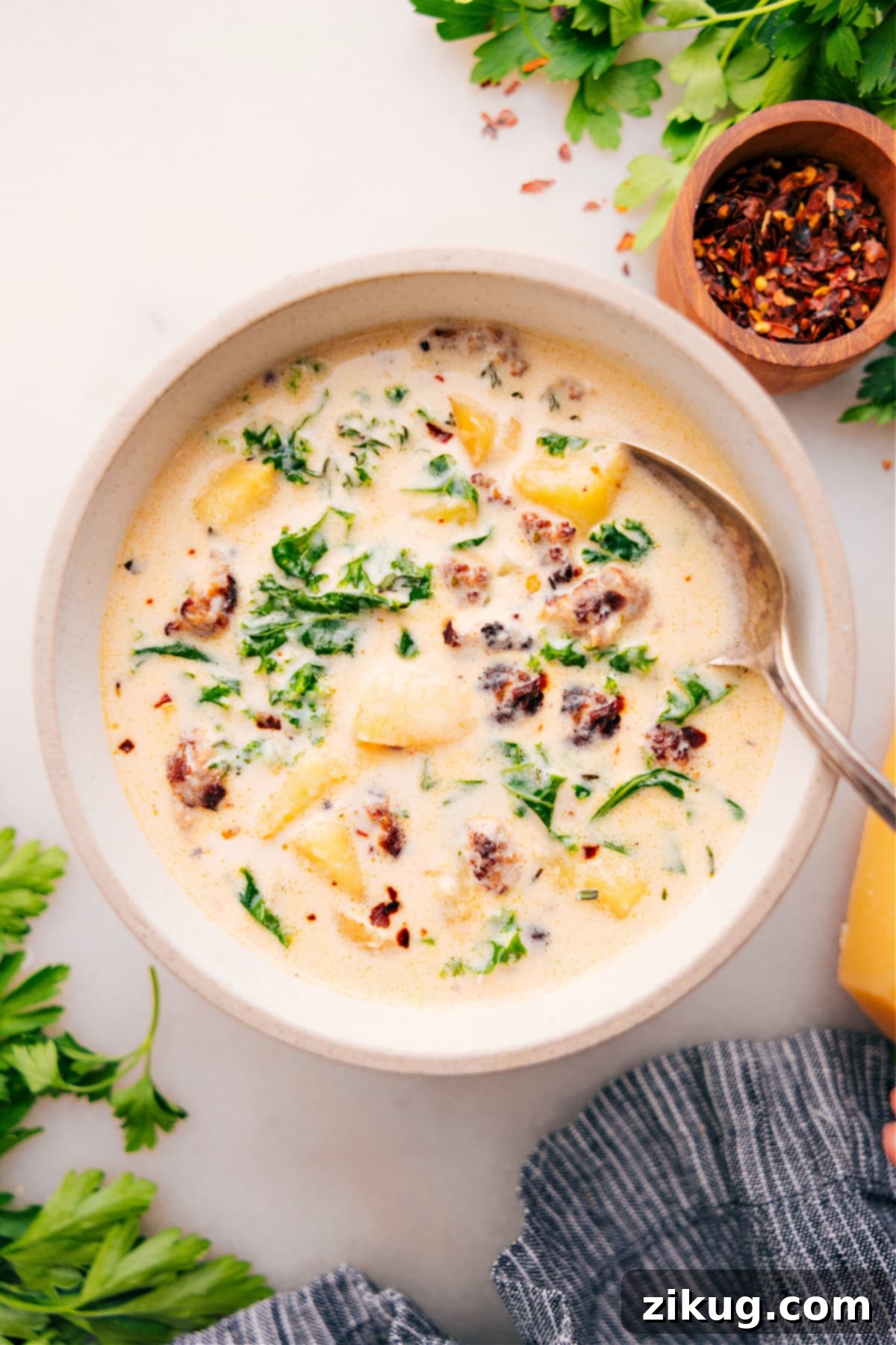 The Ultimate Homemade Zuppa Toscana Soup Recipe A large, steaming bowl of homemade Zuppa Toscana Soup, topped with crispy bacon and Parmesan cheese, ready to be enjoyed as a comforting meal.