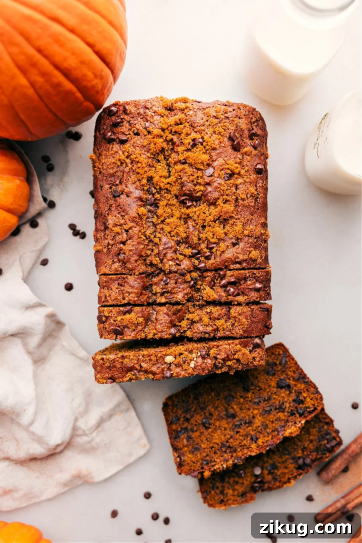 Pumpkin chocolate chip bread with slices cut out, revealing the delicious and fluffy interior.