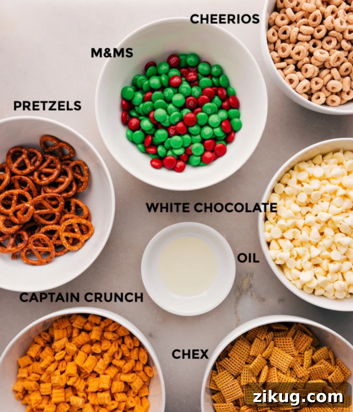 Ingredients In Christmas Snack Mix All the ingredients in this recipe are prepped for easy assembly: M&Ms, white chocolate, oil, Chex, Captain Crunch, and pretzels.
