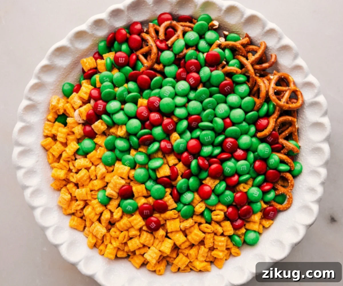 How To Make Christmas Snack Mix Add all the ingredients except the white chocolate to a bowl for the Christmas Snack Mix.