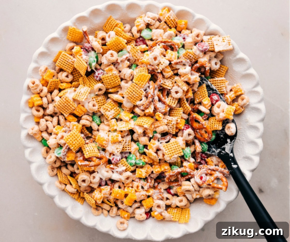 Quick And Easy Christmas Snack Mix Recipe Christmas Snack Mix tossed together in a bowl, ready to enjoy!