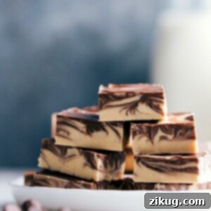 Stacked slices of Tiger Butter Fudge with distinctive chocolate and peanut butter swirls.