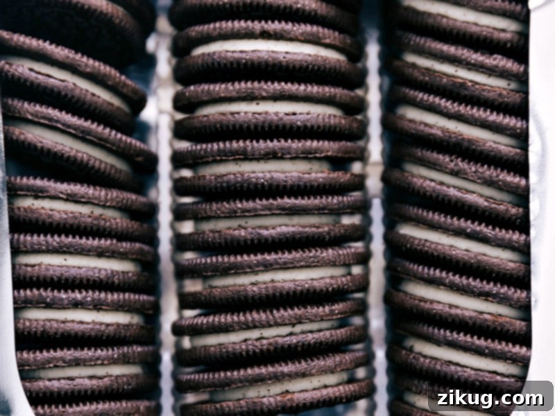 Close-up of various Oreo cookie flavors, including original, Double Stuf, and Golden, ready for dipping into melted chocolate.