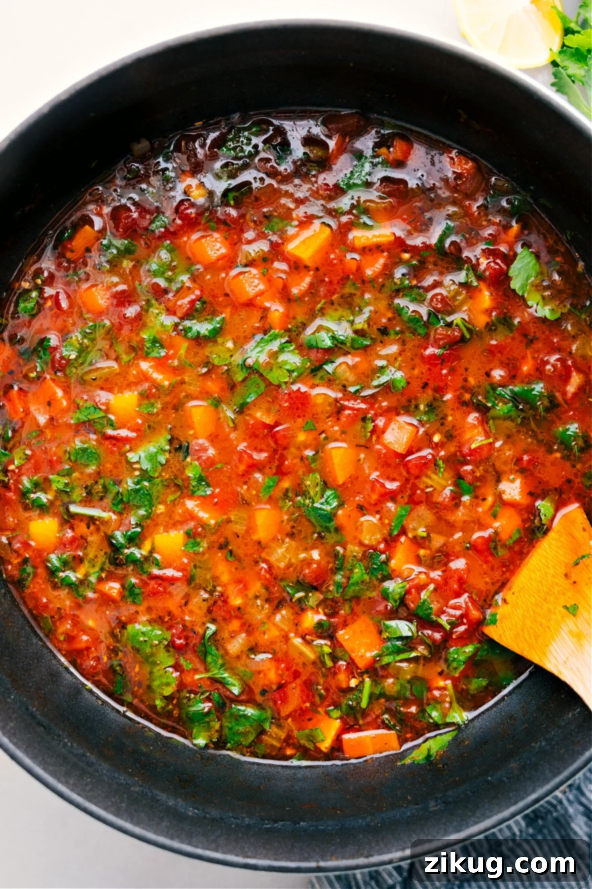 A large pot of vibrant, steaming vegetable soup, ready to be served and enjoyed.