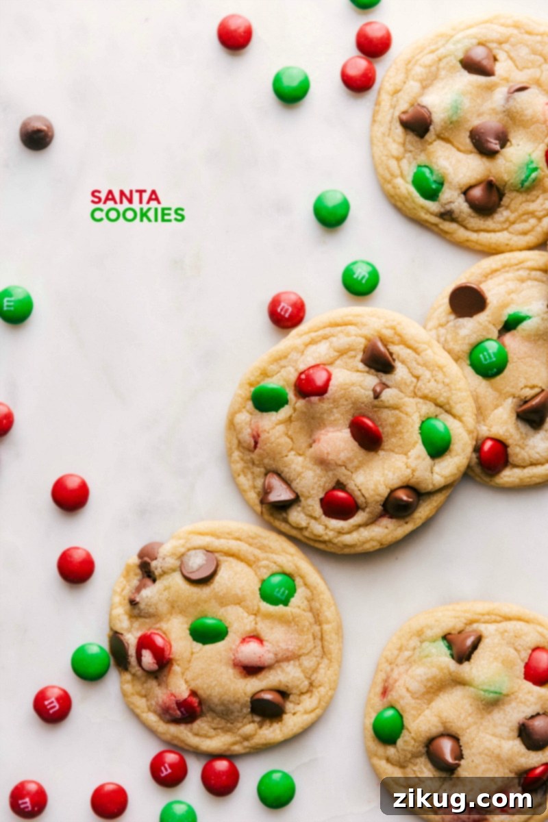 Festive Santa Cookies with Red and Green Chocolate Candies - Perfect for Holiday Celebrations A collection of festive Santa Cookies, beautifully adorned with vibrant red and green chocolate candies, ready for Christmas Eve.