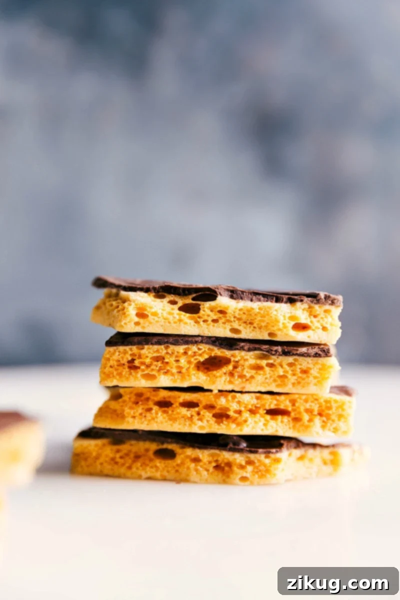 Various stacks of golden Honeycomb Candy pieces, some plain, some with chocolate drizzle