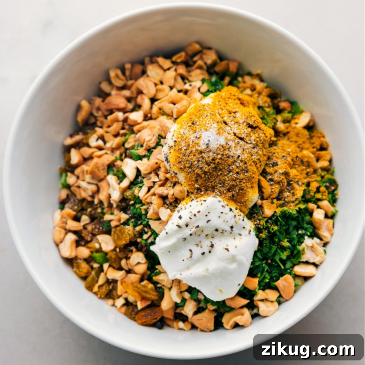 Creamy Curried Chicken Salad 4 All the ingredients for Curry Chicken Salad perfectly mixed together in a large serving bowl, ready to be enjoyed.