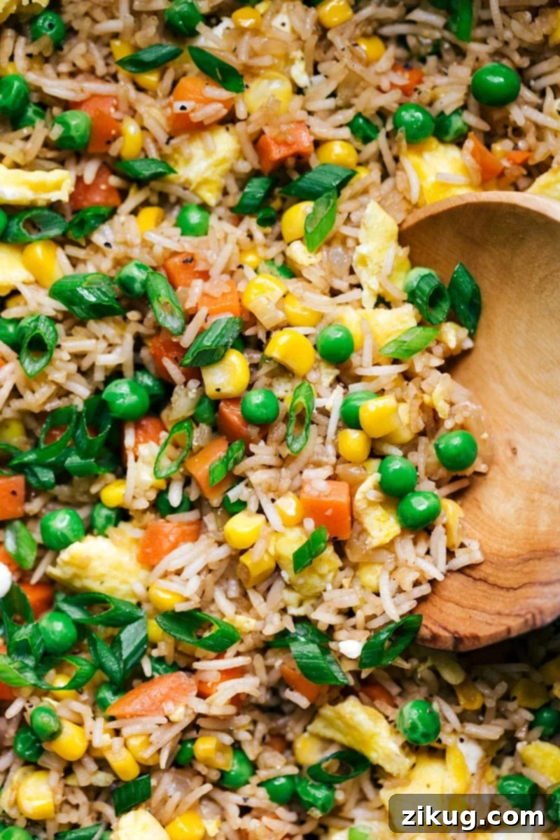 A plate of fried rice, showcasing the texture and mix of ingredients, ready to be enjoyed.