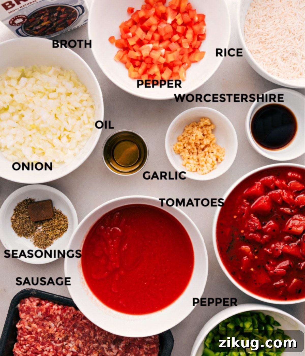 All essential ingredients for Stuffed Pepper Soup are neatly prepped: colorful bell peppers, onions, diced tomatoes, robust beef broth, ground Italian sausage, aromatic seasonings, minced garlic, Worcestershire sauce, cooked rice, and olive oil.