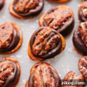 A delicious Rolo Pretzel Turtle with a perfect pecan on top, showcasing its sweet and salty appeal.