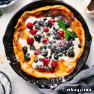 A beautifully baked Dutch Baby, golden and puffed, with a soft center, ready to be topped and served.