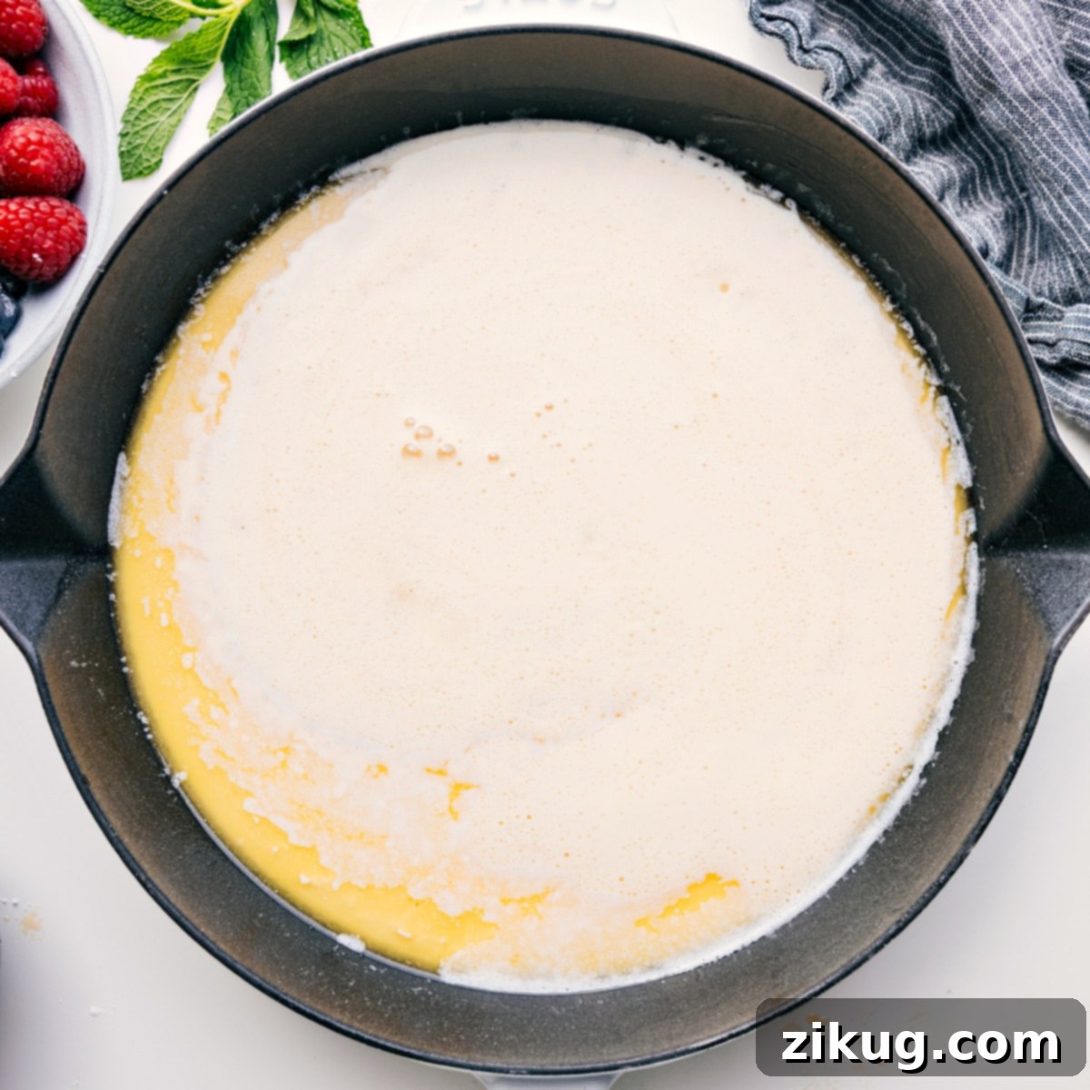 How To Make A Dutch Baby The smooth Dutch Baby batter, prepared and ready, being carefully poured into a perfectly heated and buttered skillet, just before it goes into the oven to bake to golden perfection.